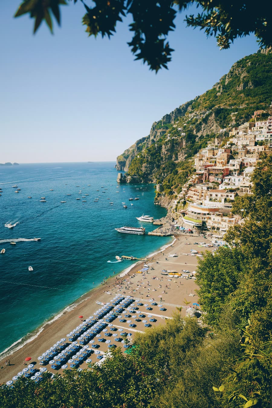 Positano’s pastel houses above a boat-filled beach on the Amalfi Coast