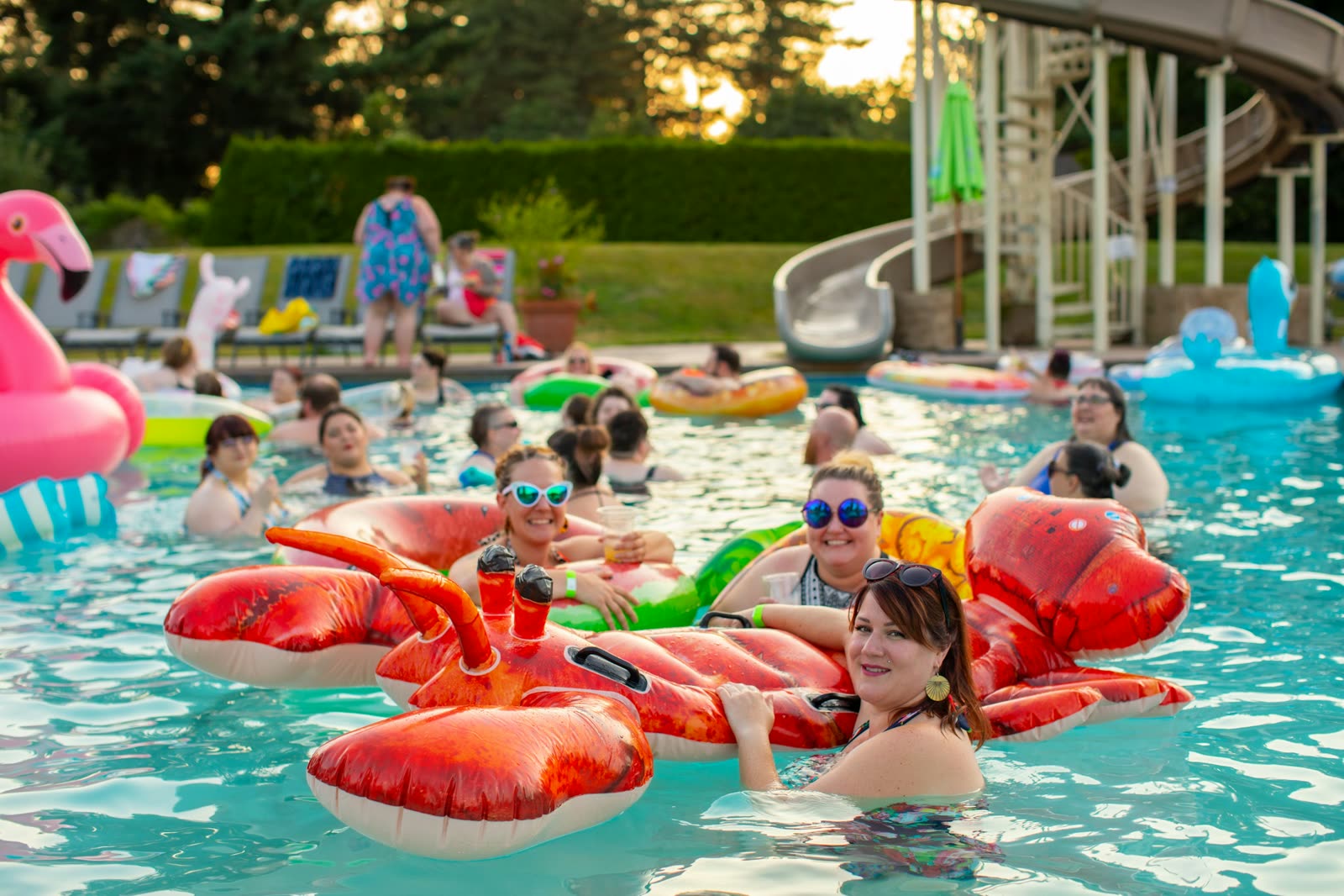 Families relaxing and swimming in a sunlit resort pool