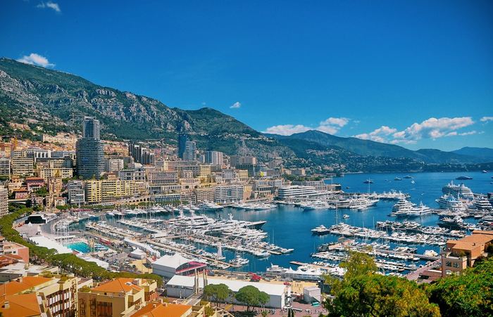 Yachts moored in Monaco’s Port Hercule below the town