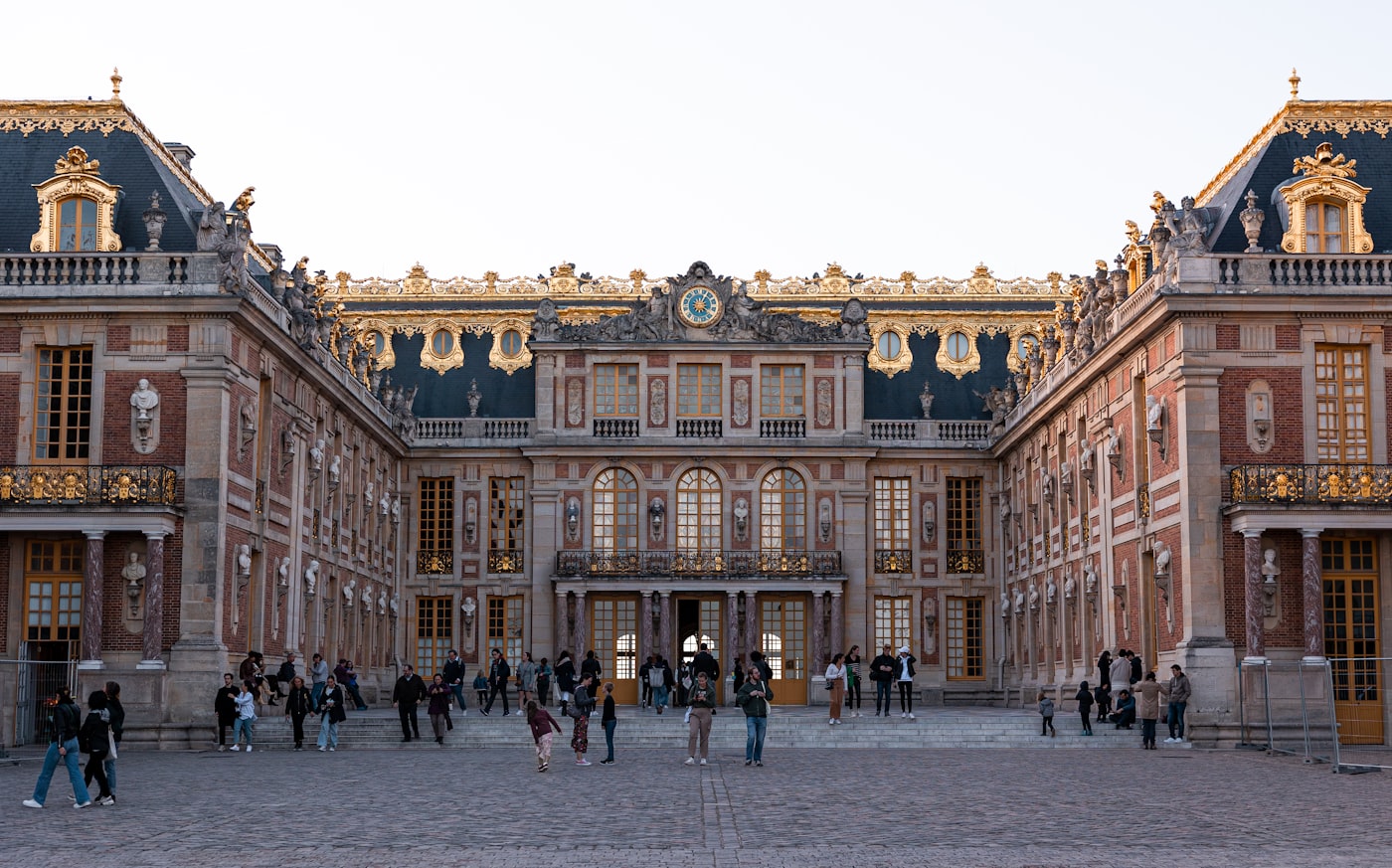 The Marble Court at the Palace of Versailles with its gilded roofline and clock